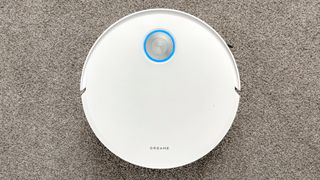 Dreame X60 Max Ultra Complete in white photographed on gray carpet.