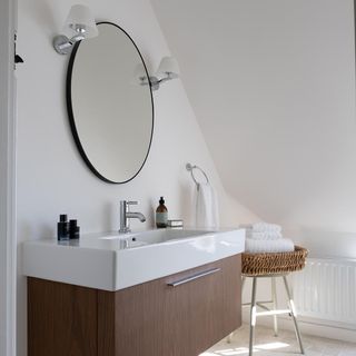 bathroom with lain white painted walls and sloped ceiling