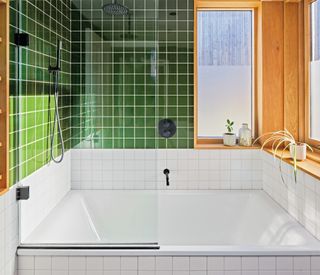Bathroom with green wall tiles, white splashback tiles and matt black hardware