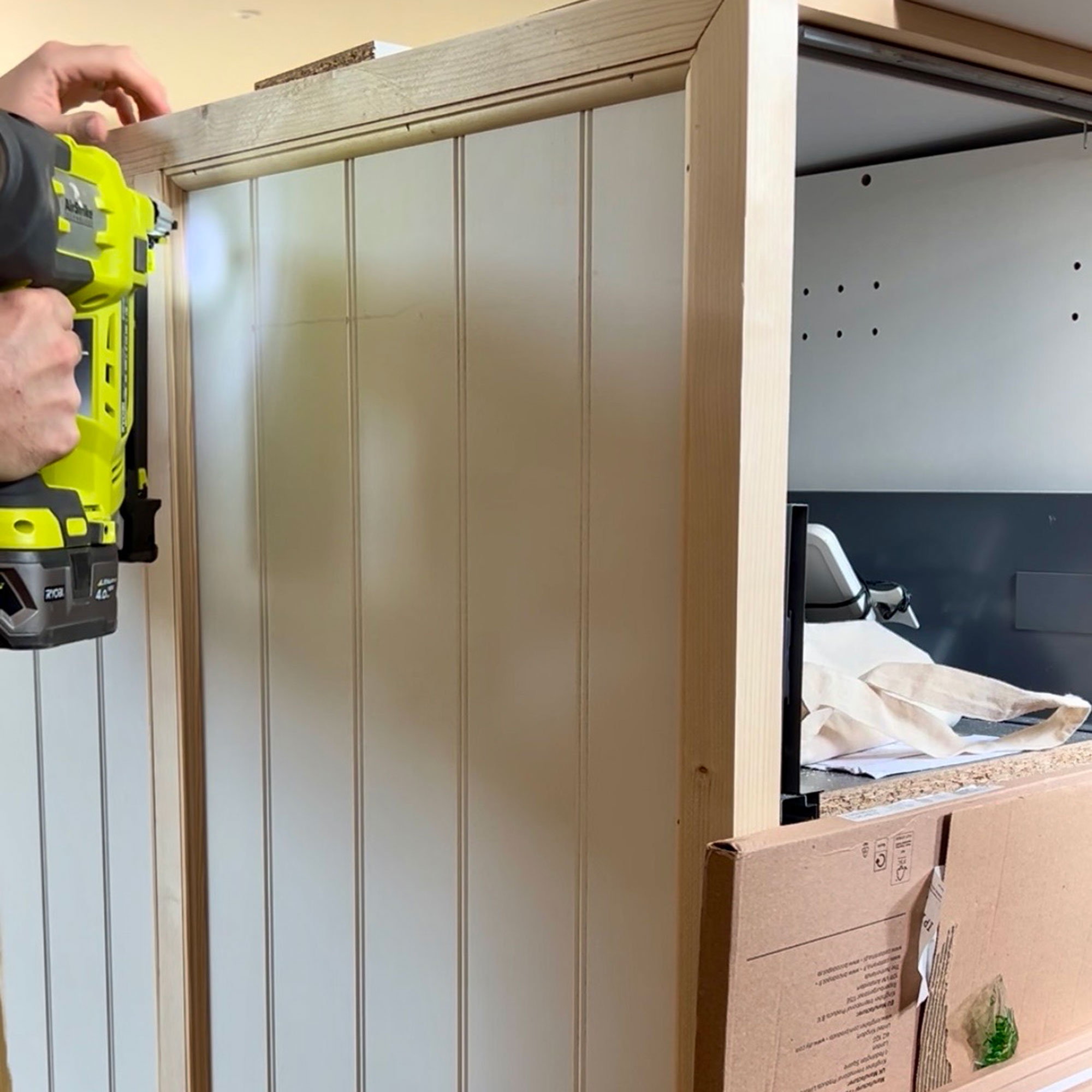 Person drilling panelling section onto side of kitchen island