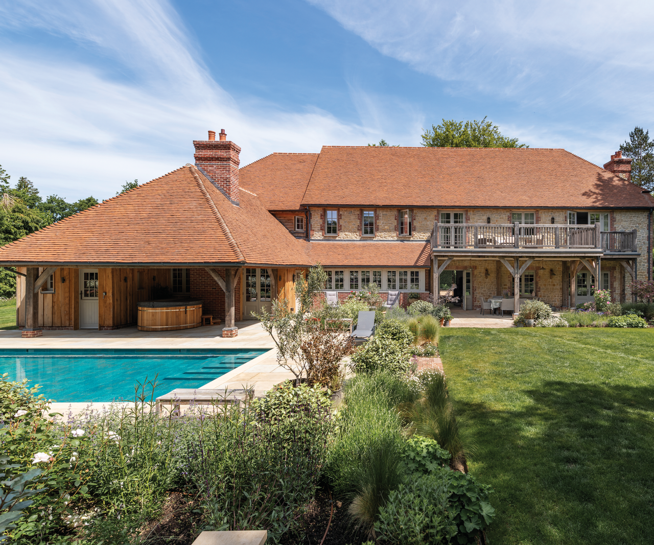 exterior of house with pool to left and lawn to right