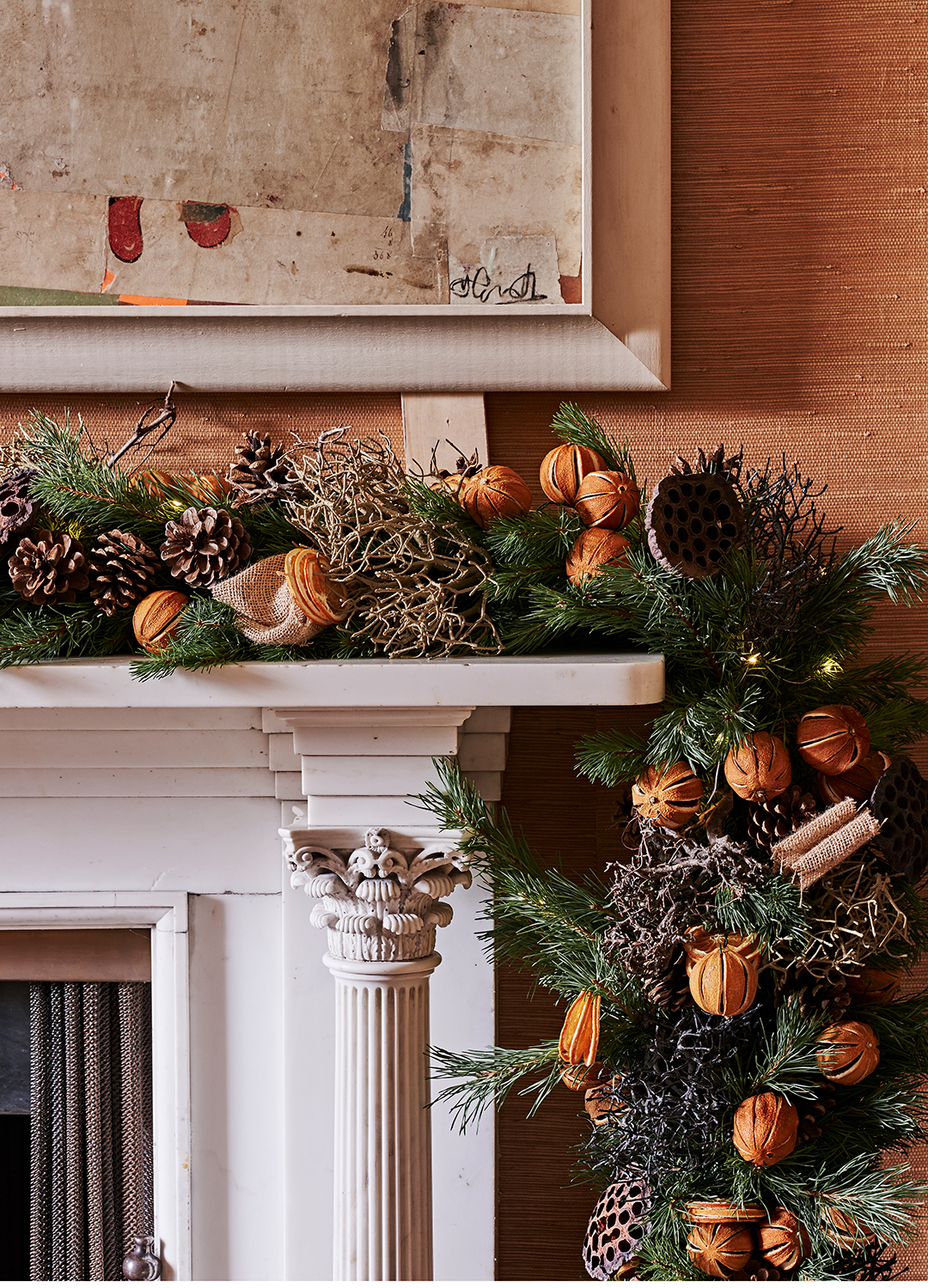foliage gland across a mantlepiece dressed with dried oranges and cinnamon sticks