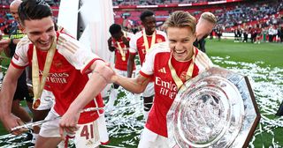 Declan Rice and Martin Odegaard of Arsenal celebrate with the FA Community Shield Trophy following the team's victory in the penalty shootout during The FA Community Shield match between Manchester City against Arsenal at Wembley Stadium on August 06, 2023 in London, England.