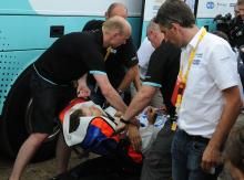 Tony Martin being moved by stretcher from the team bus to the waiting ambulance an hour after the finish