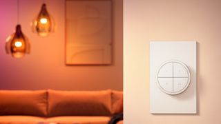 Philips Hue Tap dial switch monteret på en væg med to lysende lamper i baggrunden.