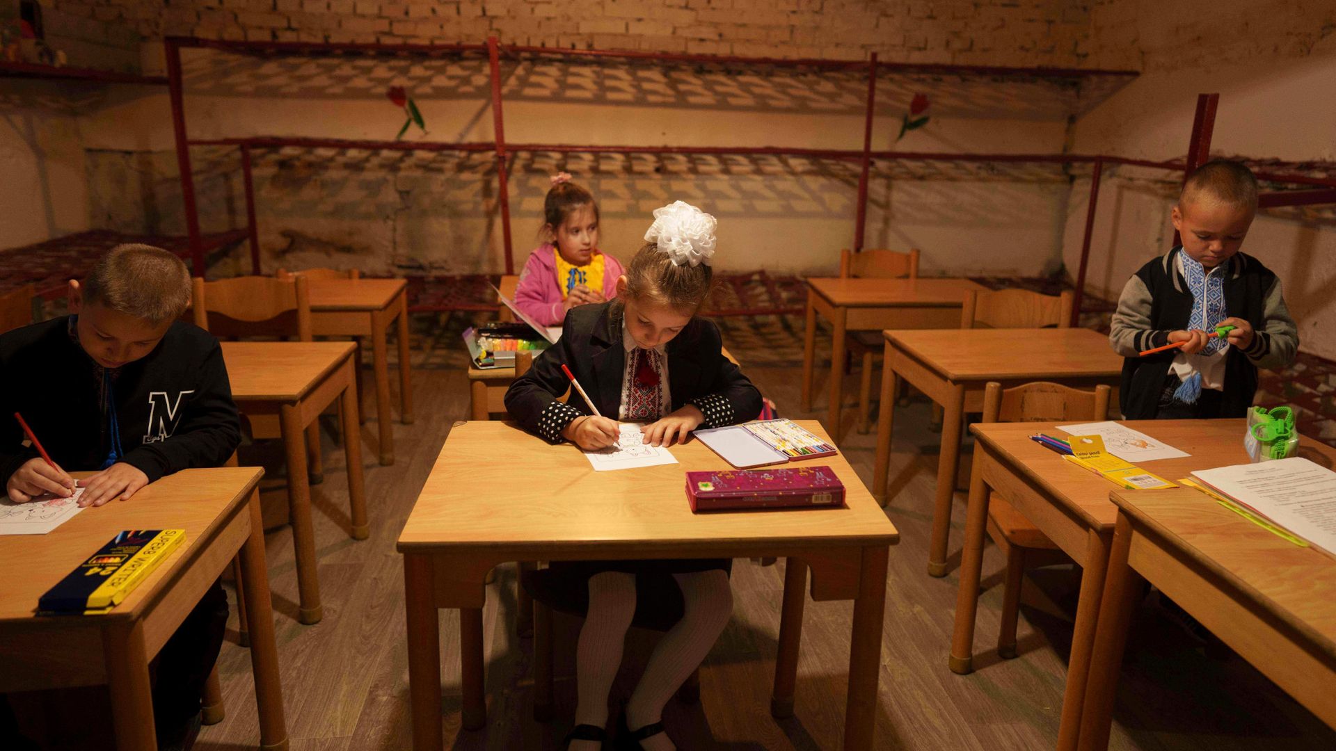 
                                Children attend classes in the basement of a building in Bobryk, Ukraine
                            