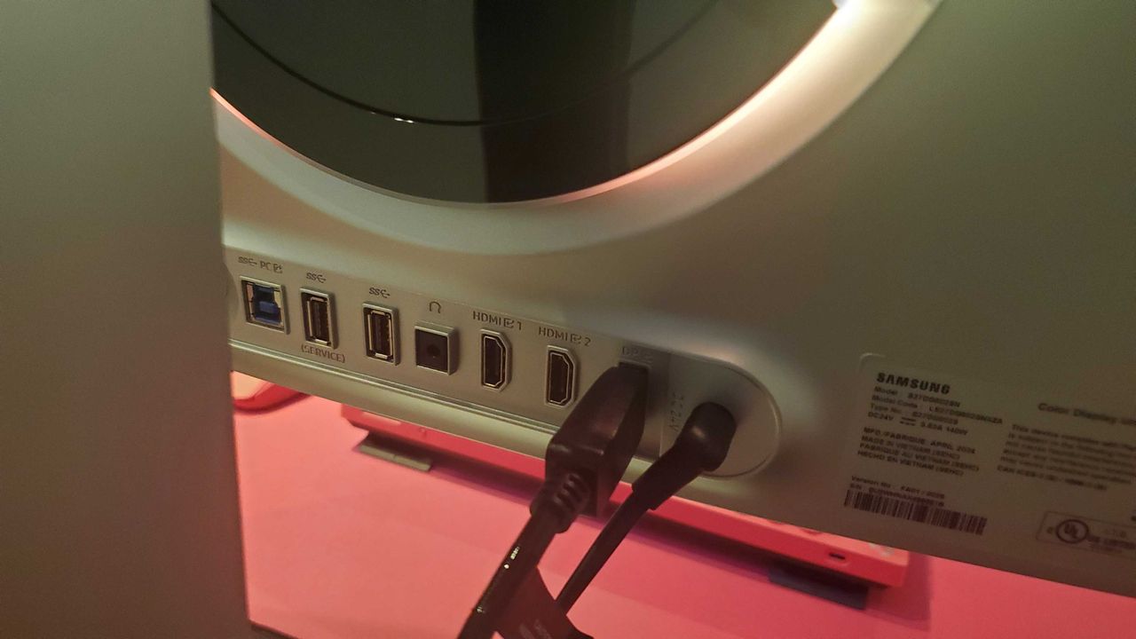 gaming monitor near pink keyboard