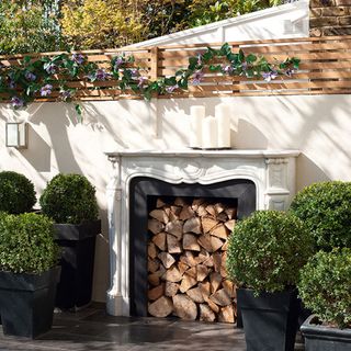 outdoor fireplace and plants pot and wood stacks