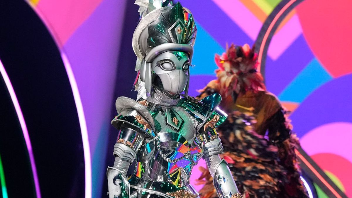 The Royal Knight struts out in a wildly shiny costume. 