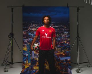 Joshua Zirkzee of Manchester United poses after signing for the club at Carrington Training Ground on July 14, 2024 in Manchester, England.