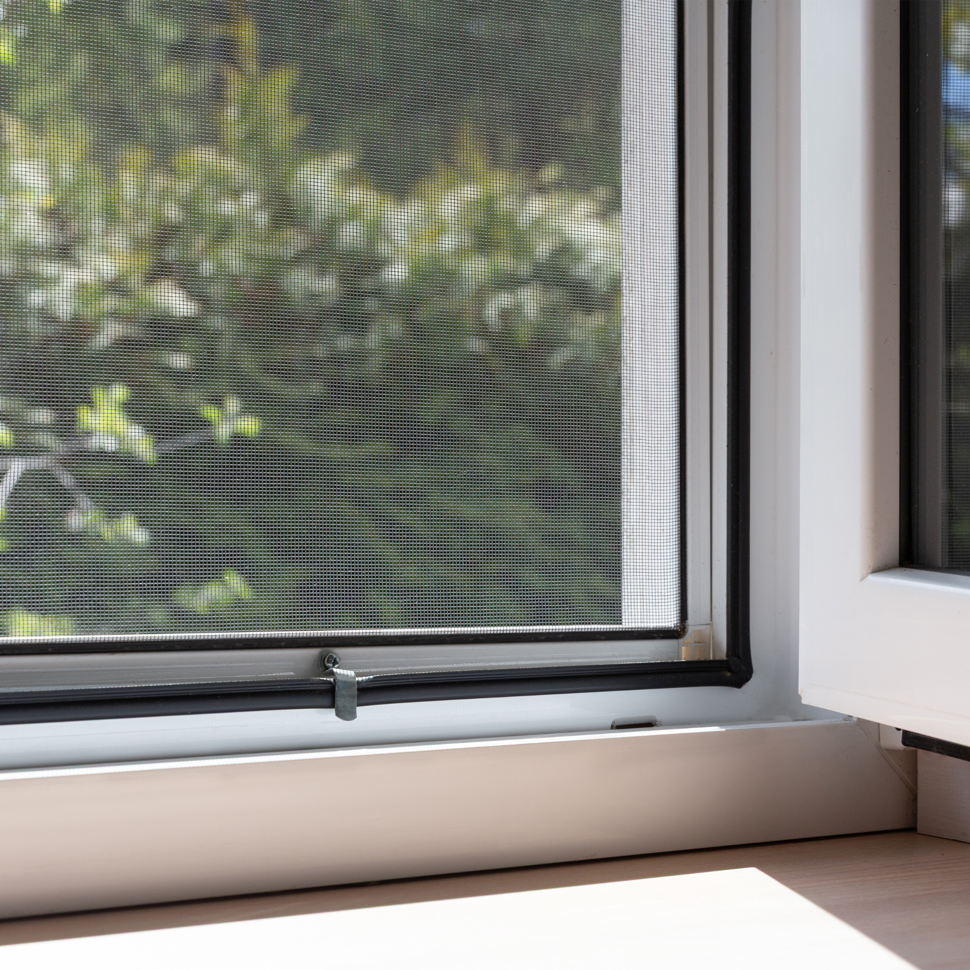 Close up of fitted fly screen in a window.