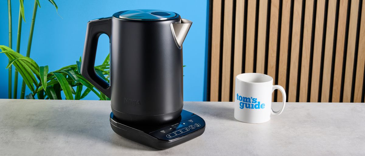 the all-black ninja precision temperature kettle, electric, with a precision temperature base for specialty tea and general kitchen use photographed making coffee