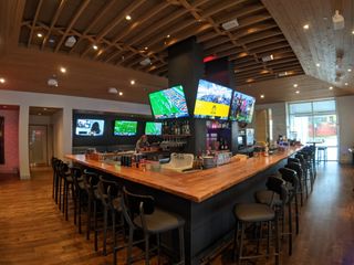 Bar area at Buckhead Atlanta restaurant Botica, featuring video displays driven by a Key Digital AV over IP system.