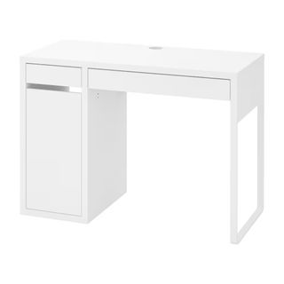 A white IKEA desk with a drawer and hole for cables