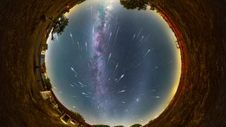 a circular overhead view of the sky and shooting stars and the milky way