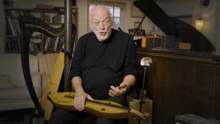 David Gilmour sitting down with a dulcimer on his lap