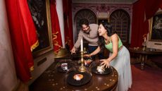 A man and a woman laugh in a challenge room at Hijinx Hotel