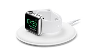 The Apple Watch Magnetic Charging Dock charging a white and silver apple watch