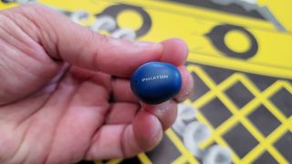 Our reviewing holding the Phiaton BonoBuds