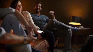 PHILIPS HUE bulb used in lamp beside man and woman