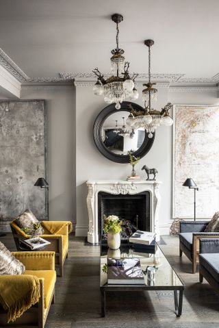 Grey and yellow living room with high ceilings distressed walls and fireplace