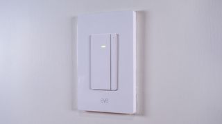 The Eve Dimmer Switch mounted on a white wall