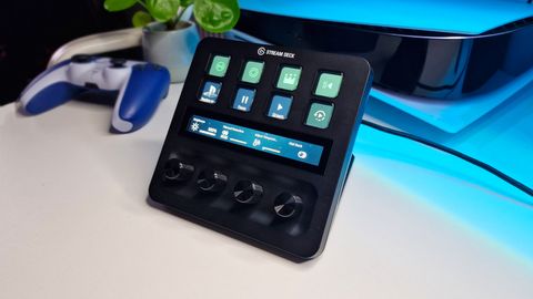 A photo of the Stream Deck + on a white desk with colourful lighting