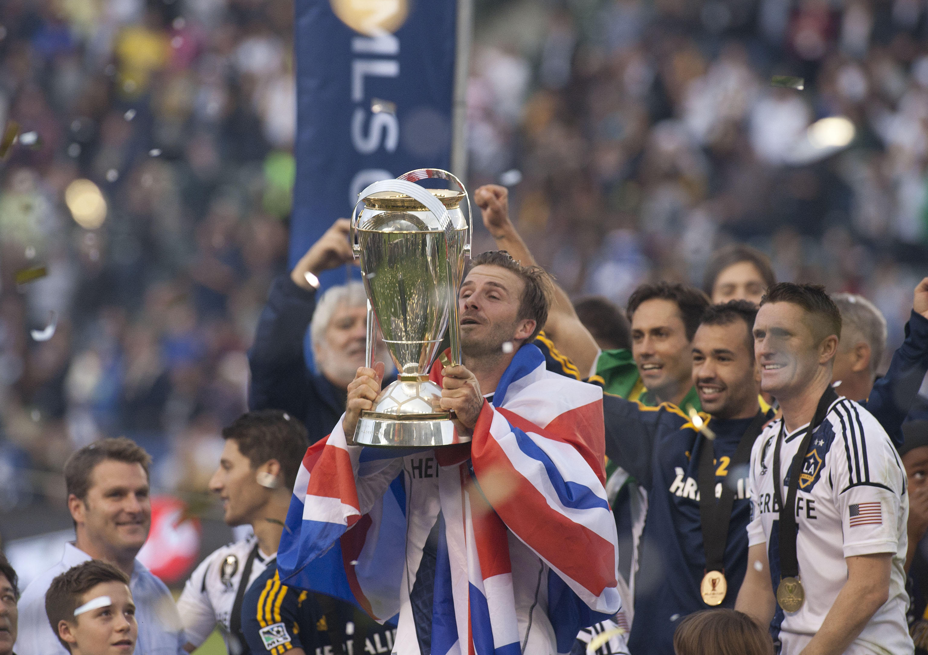 David Beckham lifts the MLS Cup after winning the 2012 MLS title with the LA Galaxy