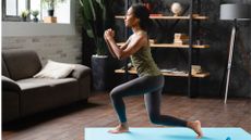 woman does a lunge exercise on mat at home