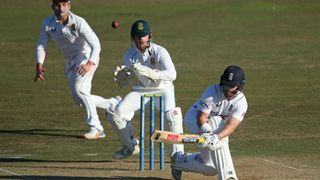 Ben Duckett of England Lions plays a sweep shot as Kyle Verreynne of South Africa looks on during day two of the tour match between England Lions and South Africa