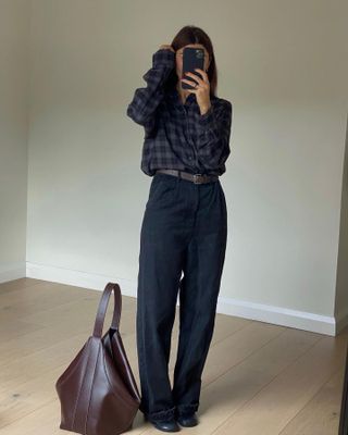 Fashion influencer Marianne Smyth takes a mirror selfie in the burgundy with navy blue color trend.