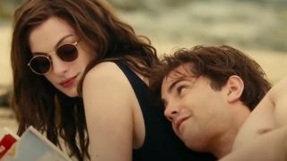 Anne Hathaway and Jim Sturgess laying on the beach in One Day.