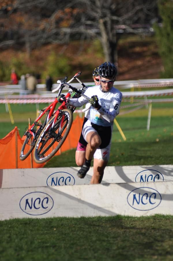 Phil Wong (Seaside Cycles) is followed closely by Jonathan Sundt (El Gato) over the barriers.