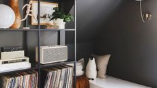 a dark-painted room with ikea furniture storing records