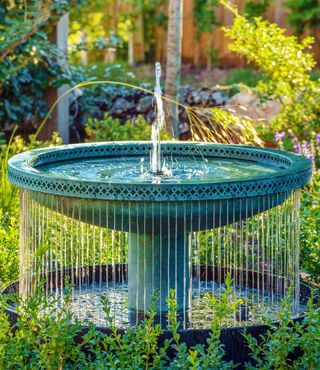 A green garden fountain