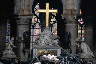 Fallen debris from the burnt out roof structure sits near the high altar inside Notre Dame Cathedral in Paris, France, on Tuesday, April 16, 2019.