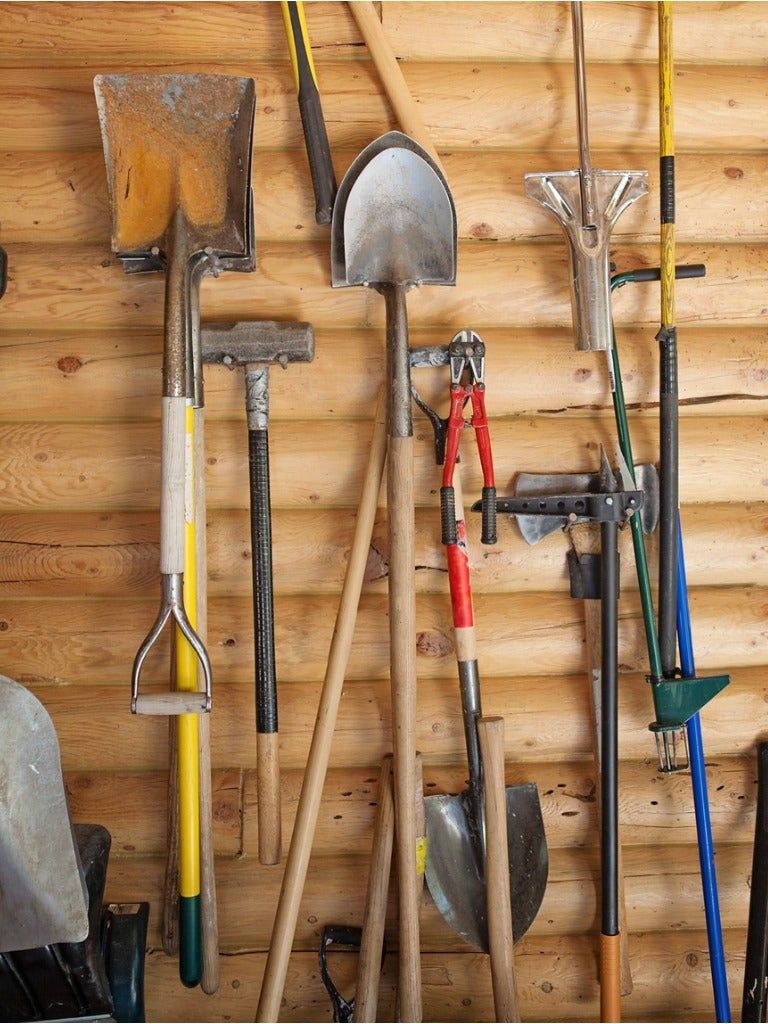 Organized Garden Tools Hanging On The Wall