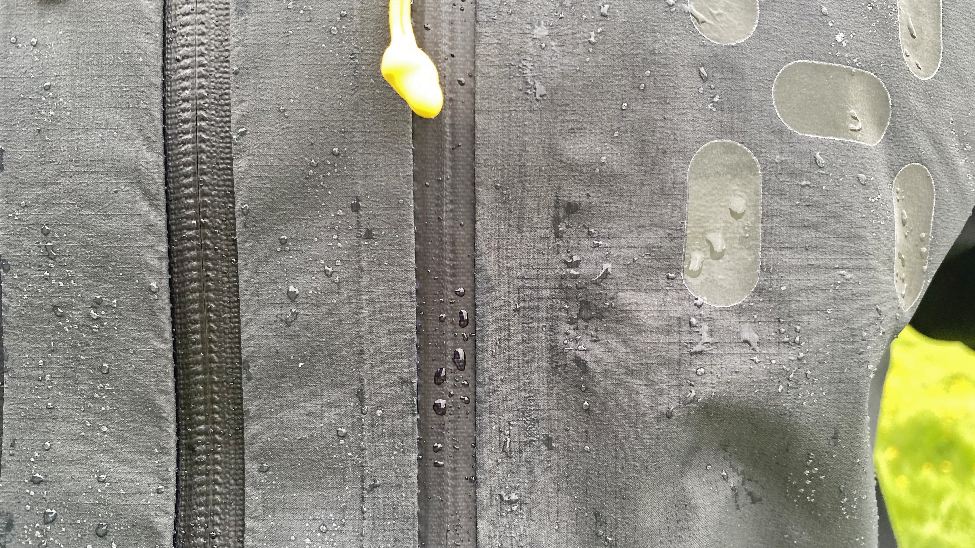 A close-up of the Haglofs L.I.M. ZT II GTX jackets, showing zips and water repellency
