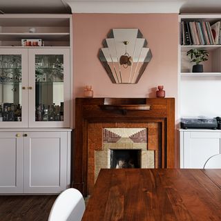 dining room with period fireplace and white cabinet