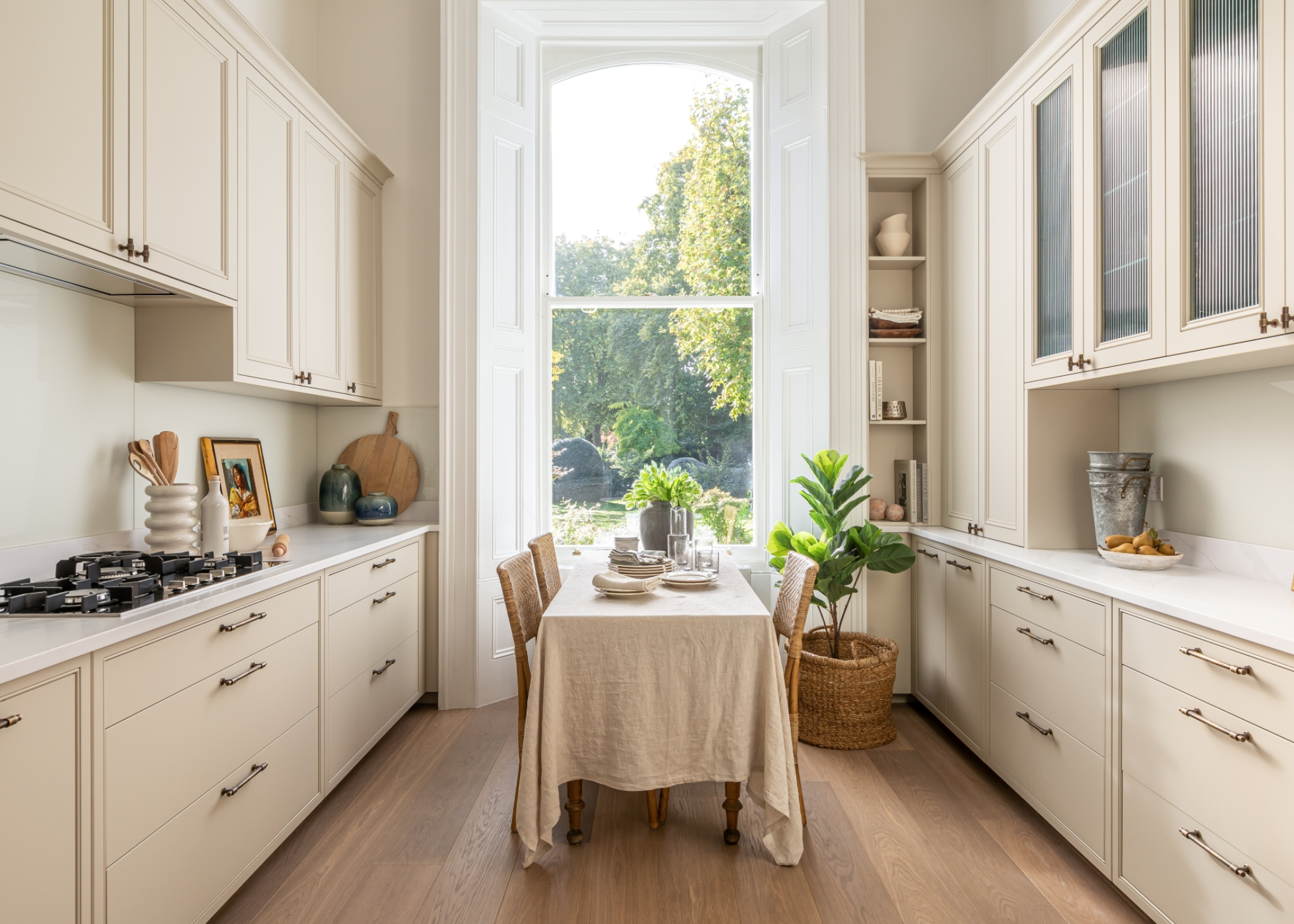 cashmere kitchen with large floor to ceiling window and a dining table