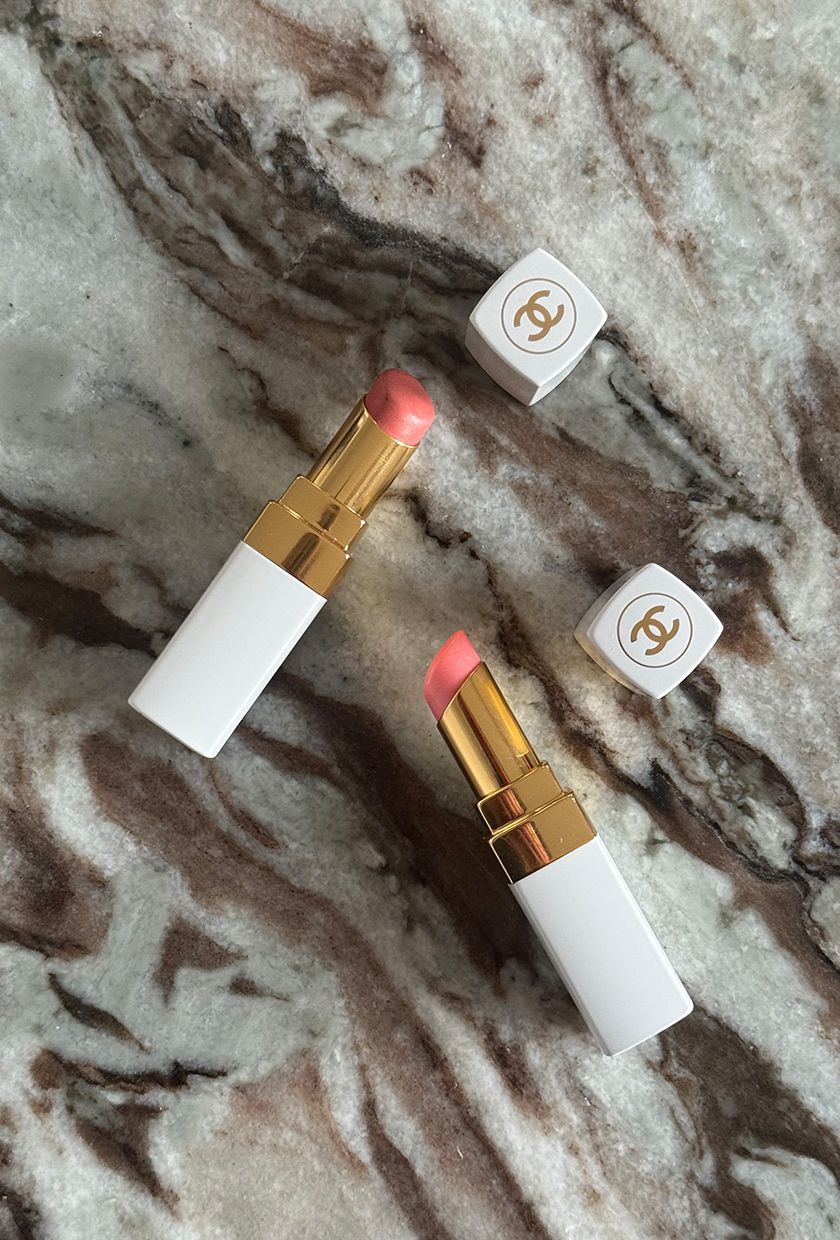 Chanel Rouge Coco Baume lip balms on a marble table