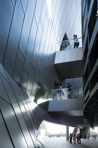 A view up of the multiple levels of the structure with students standing on the walkways.