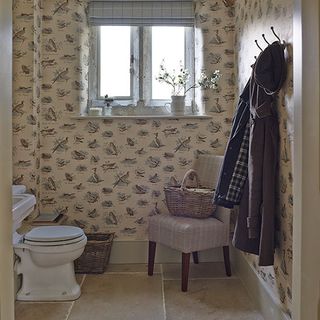 country style cloakroom with bird printed wallpaper