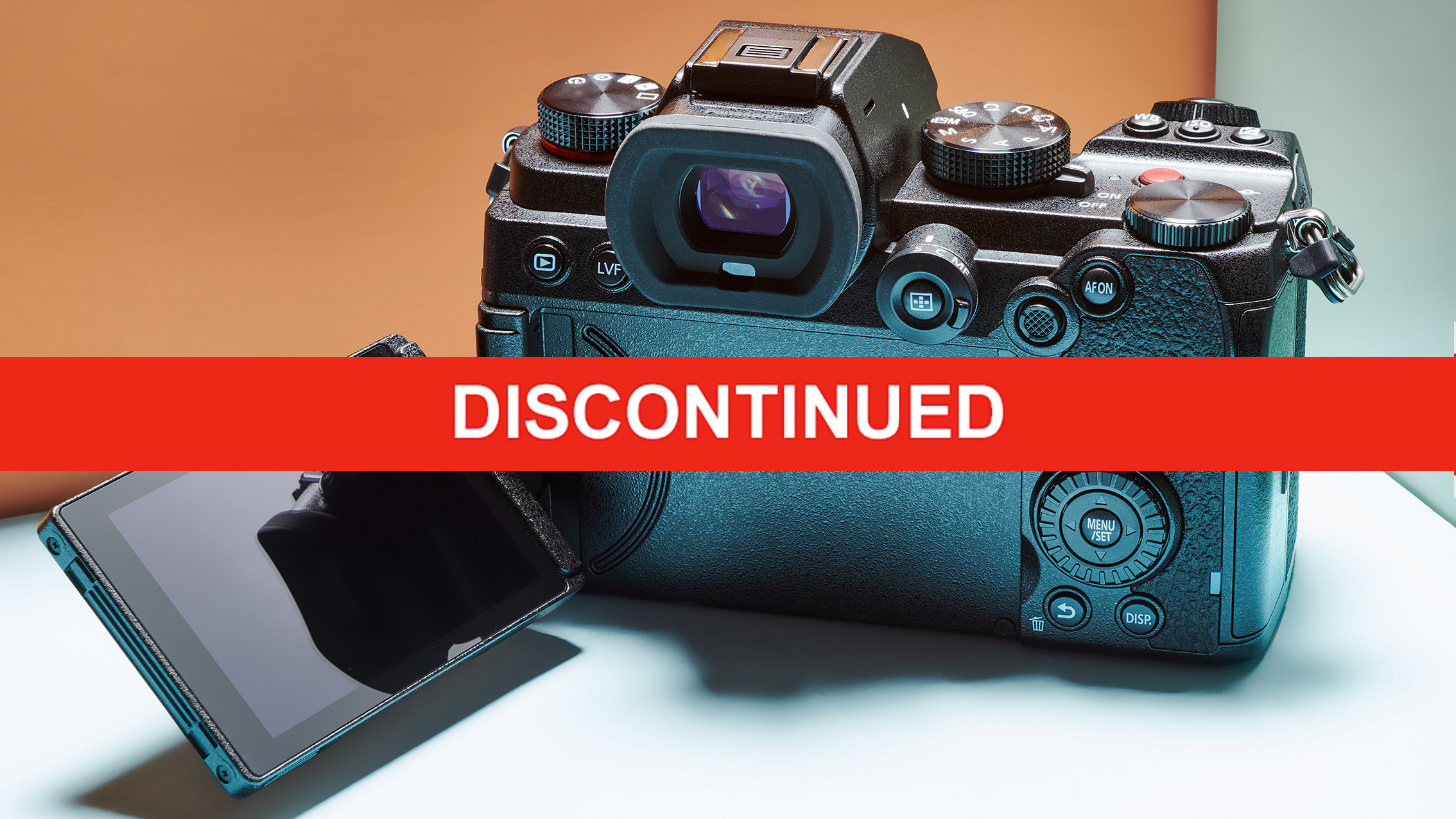 A Panasonic Lumix S5 camera with a flip-out screen is shown against a gradient background, covered by a bold red banner labeled "DISCONTINUED"