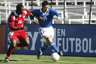 Canada's Tam Nsaliwa competes for the ball with South Korea's Cha Doo-Li in a CONCACAF Gold Cup game in February 2002.
