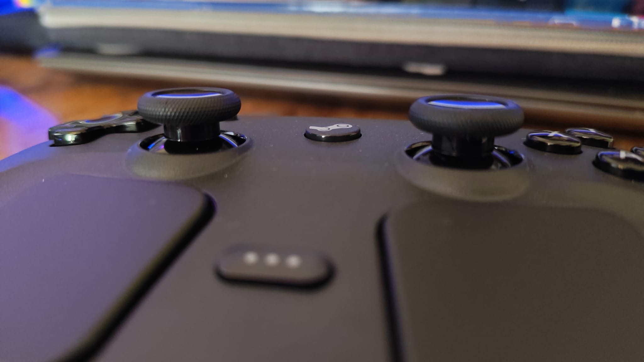 A photo from the surface of the Steam Controller with the Steam button in focus