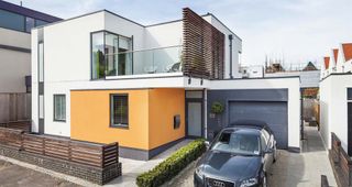 contemporary self build home with flat roof and rendered exterior