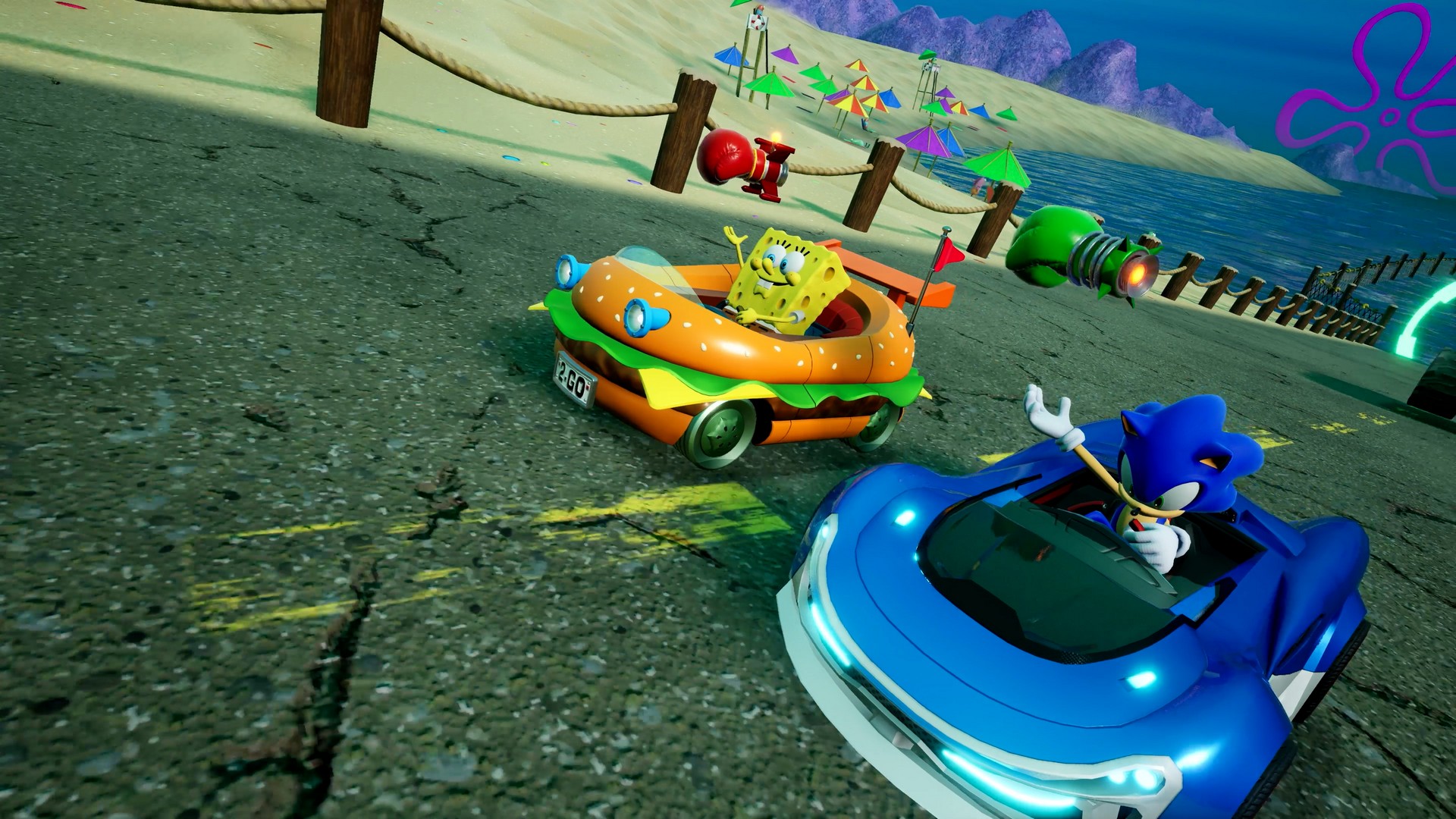 Sonic in a blue car and SpongeBob in a burger car race through Bikini Bottom in Sonic Racing: CrossWorlds