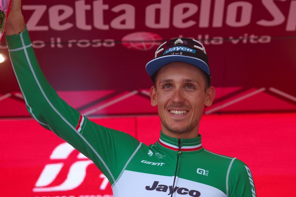Team Jayco AlUlas Filippo Zana rider celebrates on the podium after winning the eighteenth stage of the Giro dItalia 2023 cycling race 161 km between Oderzo and Val di Zoldo on May 25 2023 Photo by Luca Bettini AFP Photo by LUCA BETTINIAFP via Getty Images