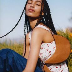 Woman in field wearing Kate Spade bag